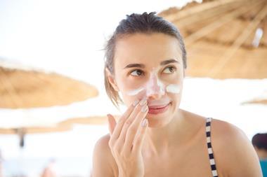 Woman putting on sunscreen