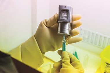 Technician preparing injection of technetium 99 prior to gamma scan examination